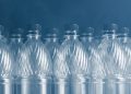 empty plastic bottles on black background with smoke, pollution concept